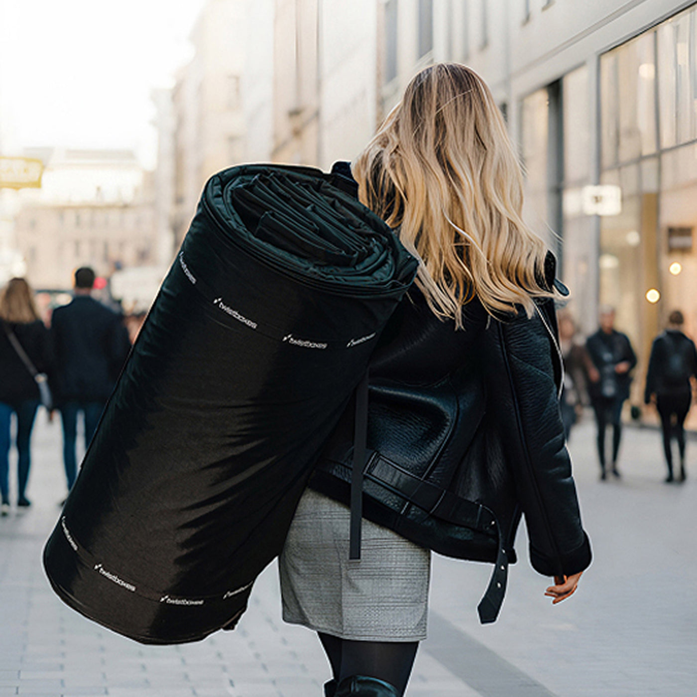 Twistboxes portable roof box being carried in rolled-up compact form